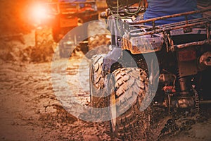 Action shot of sport atv vehicle running in mud track