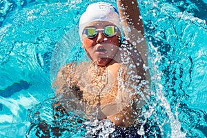 Action shot from top of boy swimming backstroke. photo