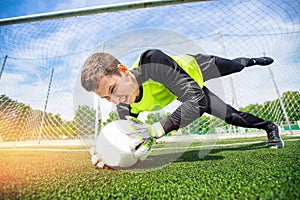 Action Soccer man player goalkeeper catching ball at penalty