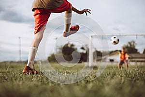 Action sport outdoors of kids having fun playing soccer football