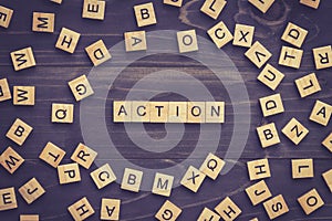 Action word on wood table for business concept.