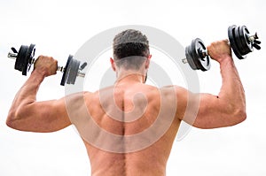 Actions speak louder than coaches. Dumbbell exercise gym. Muscular man exercising with dumbbell rear view. Sportsman