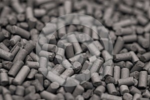 Activated carbon granules abstract background.