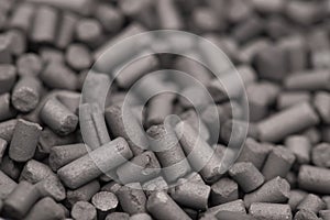 Activated carbon granules abstract background.