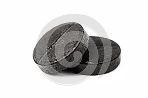 Activated carbon tablets isolated on white