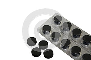 Activated charcoal pills in blister pack isolated on white background