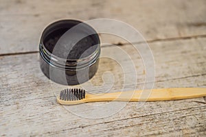 Activated charcoal powder for brushing and whitening teeth. Bamboo eco brush