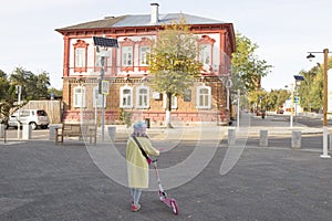 A little townswoman and her scooter photo