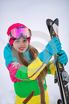 Active adorable preschooler caucasian girl portrait  goggles and bright suit enjoy winter extreme sport activities. Child skiing