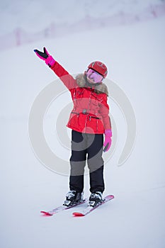 Active adorable preschooler caucasian girl portrait with ski in helmet  goggles and bright suit enjoy winter extreme sport