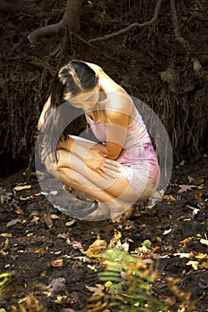 Active adult woman dancing with earthy tree roots in Connecticut