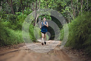 Active Asian woman trail runner running in park outdoor