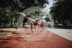 Active Athletes Practicing Cartwheel in a Sunny Park Together