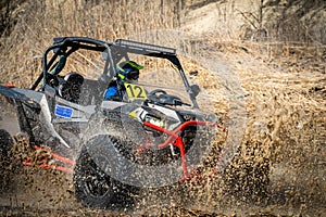 Active ATV and UTV Off-Road vehicle in muddy water. ATV 4x4