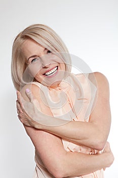 Active beautiful middle-aged woman smiling friendly and looking into the camera. Woman's face close up.