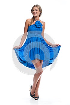 Active beautiful pregnant model in a blue dress sarafan on a white background. Clothes for pregnancy