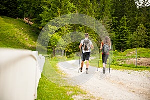 Active Beautiful young couple hiking ina nature climbing hill or