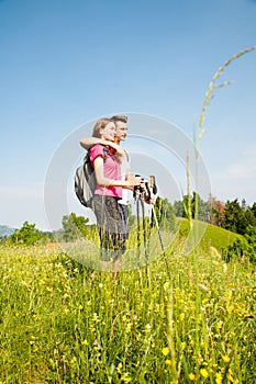 Active Beautiful young couple hiking ina nature climbing hill or