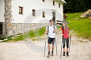 Active Beautiful young couple hiking ina nature climbing hill or