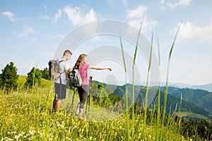 Active Beautiful young couple hiking ina nature climbing hill or