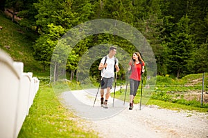 Active beautiful young couple hiking ina nature climbing hill or