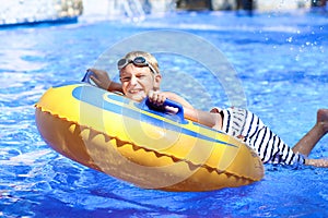 Active boy enjoying water slide in aquapark