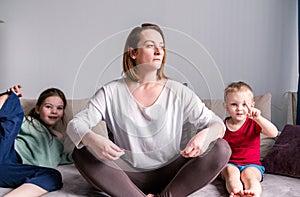 Active children sitting on sofa with mom.  Feeling unwell depression or education difficulties concept. Children play, and mom