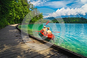 Active couple canoeing and enjoying the view, lake Bled, Slovenia