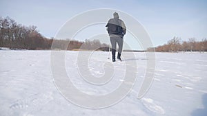 Active an elderly woman engaged in Nordic walking with sticks in the winter forest. Healthy lifestyle concept. Mature