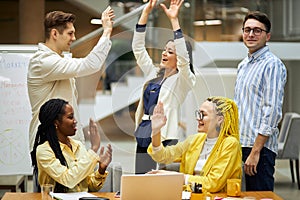 Active enthusiastic business team giving high five