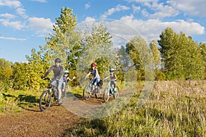 Active family on bikes cycling outdoors