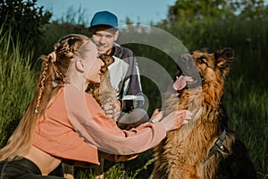 Active Family, fitness couple, Pet Love, Dog Training, best dog breeds for family. Young sports couple walking with two