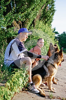 Active Family, fitness couple, Pet Love, Dog Training, best dog breeds for family. Young sports couple walking with two