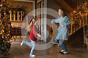 Active family having fun near Christmas tree.