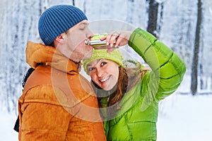 Active family walking in the winter forest.