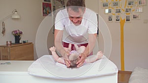 Active father makes gymnastic little girl It perceptive hands delineation senses