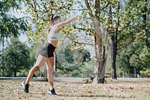 Active and fit girls having fun and exercising outdoors in a beautiful park, throwing a ball and enjoying a sunny day in