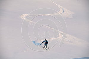 active freerider skilfully rides down white powdery snow of mountain slope