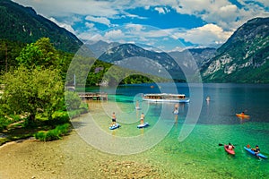 Active friends kayaking and paddling on the sup boards, Slovenia