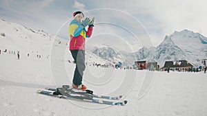 Active girl skiing in mountains. Ski race for young children. Little skier racing in snow