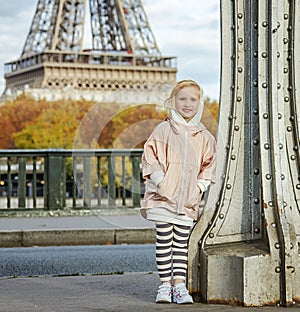 Active girl standing on Pont de Bir-Hakeim bridge in Paris