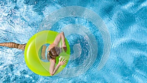 Active girl in swimming pool aerial drone view from above, young woman swims in blue water, tropical vacation