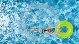 Active girl in swimming pool aerial drone view from above, young woman swims in blue water, tropical vacation