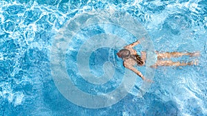 Active girl in swimming pool aerial drone view from above, young woman swims in blue water, tropical vacation