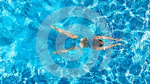 Active girl in swimming pool aerial drone view from above, young woman swims in blue water, tropical vacation, holiday on resort