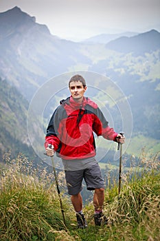 Active handsome young man nordic walking