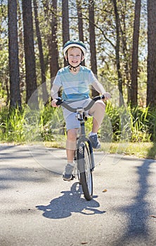 Active, Healthy Boy riding his bike outdoors on a sunny day