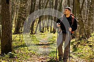 Active healthy man hiking in beautiful forest