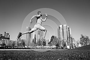 Active healthy runner jogging outdoor. Healthy lifestyle middle aged man runner running on urban citi San Diego.