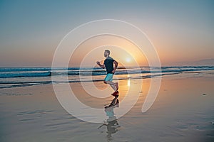 Active healthy runner jogging outdoor. Young and active jogger running on beach sunset.